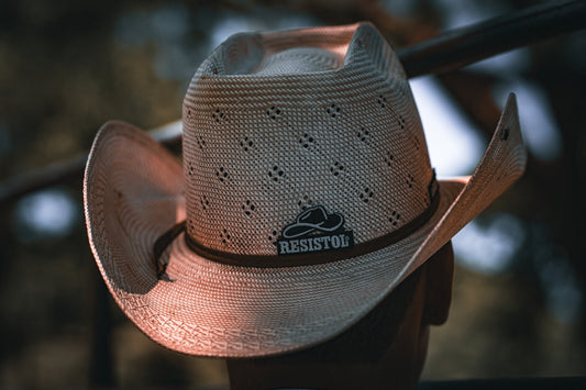 a white cowboy hat sitting on top of a hat rack