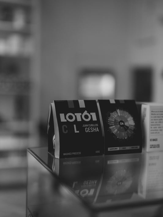 Two bags of coffee beans on a shelf.